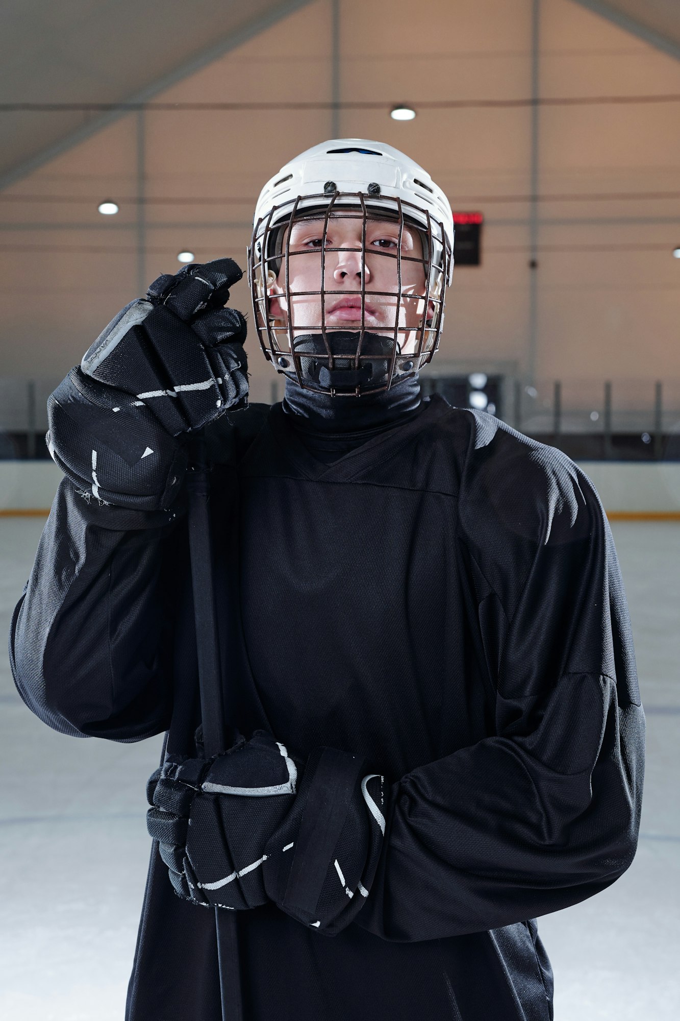 Professional hockey player in black sports uniform standing on rink after play